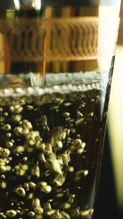Macro vertical shooting of white wine in glass, bubbles slow motion Stock Footage 329911832