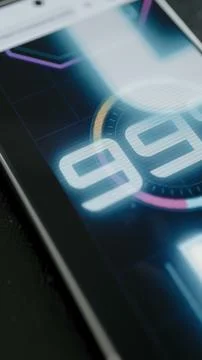 Macro vertical touchscreen animation shows a luminous percentage gauge 스톡 사진