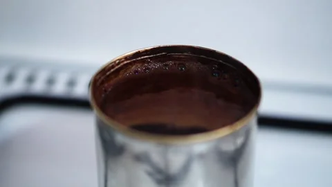 Macro video of air bubbles of foam when boiling coffee drink over burning g.. Video stock 301102142
