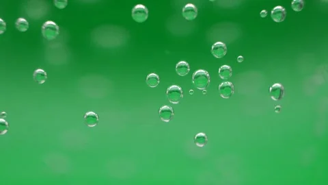 Macro video of air bubbles in water on a green background. Stock Footage 297083240