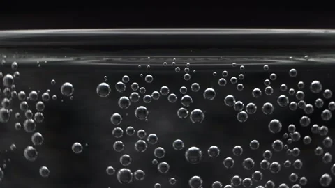 Macro video of air bubbles in water on a black background. Stock Footage 297083429