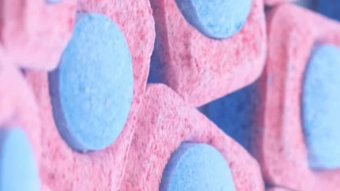 Macro video of capsules of solid washing powder. The concept of washing clothes Stock Footage 250028530