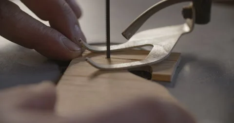 Macro video: carpenter uses automatic jigsaw and cuts small plywood parts Stock Footage 149209016