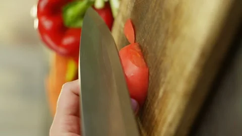 Macro video of cutting a tomato with half rings by woman hands. Stock Footage 296363039