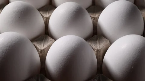 Macro video of endless white eggs: textured shells in a cardboard carton. Stock Footage 318851030