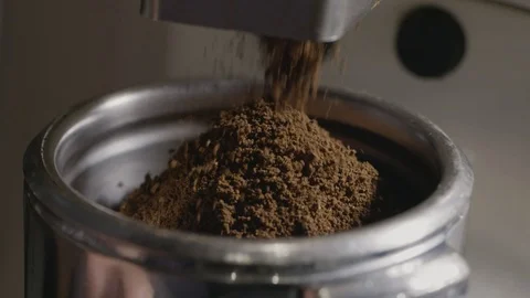 Macro video finely ground coffee pours into the metal holder. Slow motion, Full Stock Footage 129638519