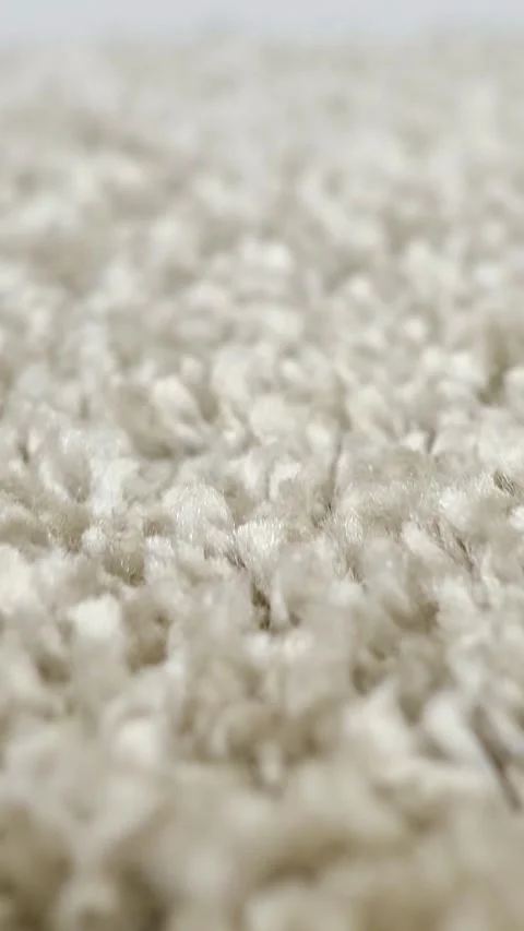 Macro video flying over a soft beige carpet, showing the detailed fluffy texture Stock Footage 343909430