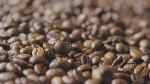 Macro video freshly roasted coffee beans fall on the grain. Slow motion, Full HD Video stock 129637469