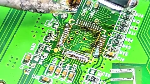 Macro Video of IC Desoldering Process on Motherboard Stock Footage 333503814