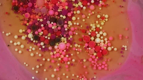 Macro video microscope view of multi-colored bubbles in oil. Stock Footage 279563526
