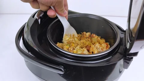 Macro Video of a multicooker. The man opens the pan and mixes the dish. Steam ca Stock Footage 139805763