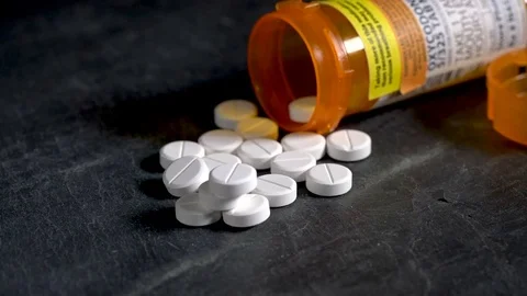 Macro video of Oxycodone Opioid tablets on slate table Stock Footage