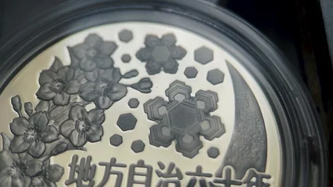 Macro Video of Reverse Side Japanese 1000 Yen Silver Coin Stock Footage 334162687