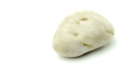 Macro video shot of isolated white pebble Stock Footage 83482637