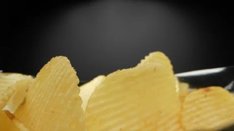 A macro video showcases a bag of Wavy Potato chips Stock Footage 244801581
