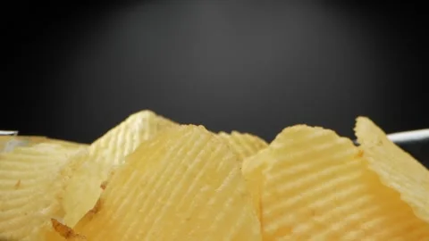 A macro video showcases a bag of Wavy Potato chips Stock Footage 244801583