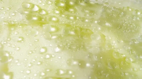 A macro video showcases a green cabbage glistening with droplets of water Stock Footage 244801176