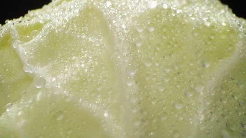 A macro video showcases a green cabbage glistening with droplets of water Stock Footage 244801183