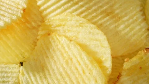 Macro video showcases the mesmerizing details of wavy potato chips Stock Footage 244801453