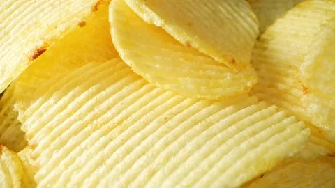 Macro video showcases the mesmerizing details of wavy potato chips Video stock 244801460