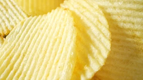 Macro video showcases the mesmerizing details of wavy potato chips Video stock 244801477