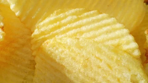 Macro video showcases the mesmerizing details of wavy potato chips Stock Footage 244801478