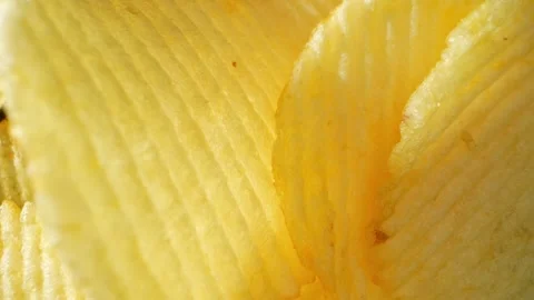 Macro video showcases the mesmerizing details of wavy potato chips Stock Footage 244801480