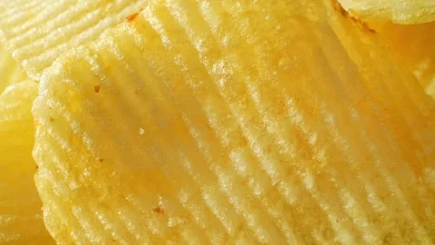 Macro video showcases the mesmerizing details of wavy potato chips Stock Footage 244801488