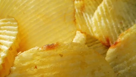 Macro video showcases the mesmerizing details of wavy potato chips Stock Footage 244801490