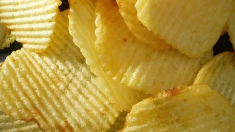 Macro video showcases the mesmerizing details of wavy potato chips Video stock 244801503