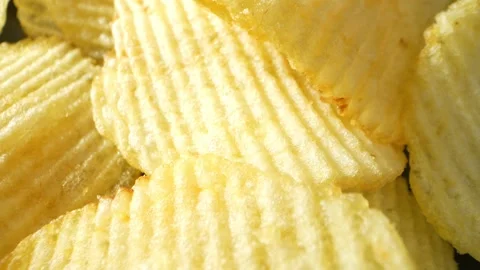 Macro video showcases the mesmerizing details of wavy potato chips Stock Footage 244801509