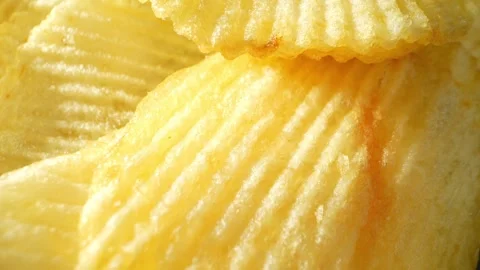 Macro video showcases the mesmerizing details of wavy potato chips Stock Footage 244801523