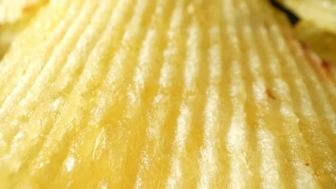 Macro video showcases the mesmerizing details of wavy potato chips Stock Footage 244801526
