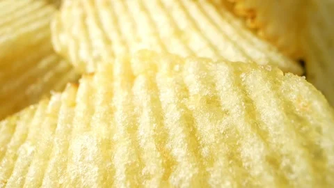 Macro video showcases the mesmerizing details of wavy potato chips Stock Footage 244801532