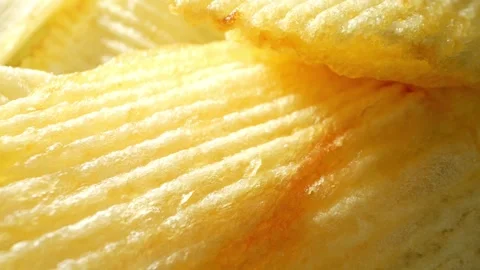 Macro video showcases the mesmerizing details of wavy potato chips Video stock 244801534