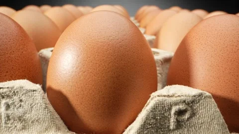 Macro video showcasing fresh eggs nestled in a delicate paper tray. Video stock 246594856