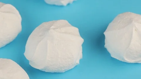 Macro Video of Soft, Fluffy, White Marshmallows on Blue Background. Видео 87834501
