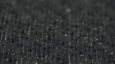 Macro video texture thin knitted fabric dark gray with lurex. closeup rotation. Stock Footage 257845451