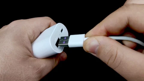 Macro video of a USB connector in which a white USB cable is included. At the tu Stock Footage 125102118