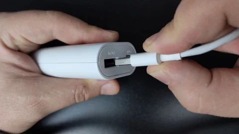 Macro video of a USB connector in which a white USB cable is included. At the tu Stock Footage 125102138