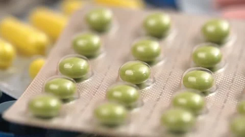 Macro video various multicolored rotating tablets and medicines in blister pack. Stock Footage 252913218