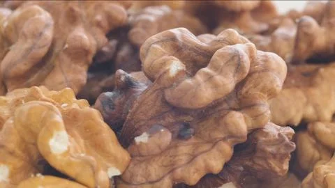 Macro video of walnuts spinning in a circle Stock Photos