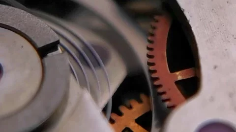 Macro Video of Watch Movement Rotating Orange Gear and Hairspring Видео 346503477
