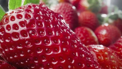 Macro video of water drop falling off the strawberry. Video stock 242589080