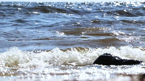 Macro of video waves on a sunny beach. Close-up of a sea wave, ocean wave Stock Footage 90094980