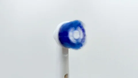 Macro video of a working electric toothbrush. Close-up shows the nozzle head, th Stock-Footage 124946848