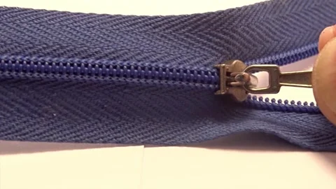 Macro video of zipper slider closing the blue plastic teeth 스톡 동영상 337310365