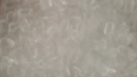 Macro view from above of ice cubes fly up. Raspberry drink poured into ice cubes Video stock 117407205