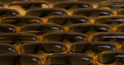Macro view and dynamic lightind: Vitamins supplements pills omega 3. Fish oil Stockbeeldmateriaal 108102944