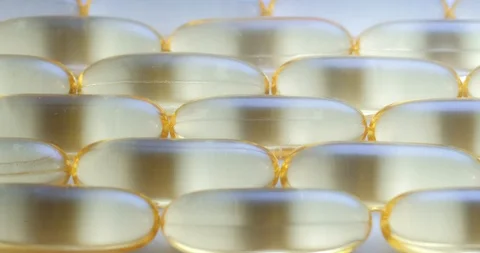 Macro view and dynamic lightind: Vitamins supplements pills omega 3. Fish oil Stockbeeldmateriaal 108103385
